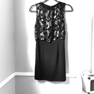 Black mini dress with faux leather embellishment